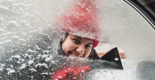 Woman Scraping Ice off Vehicle Window