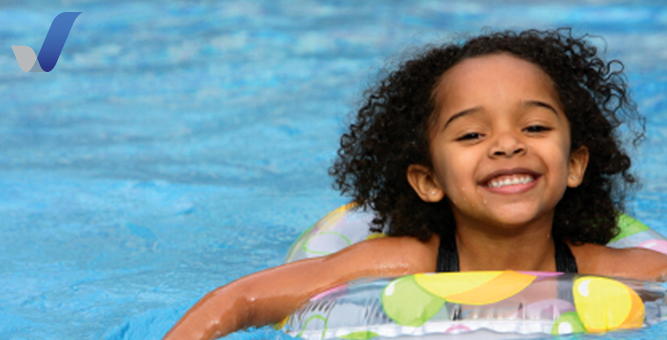 Girl swimming in water on a floatie