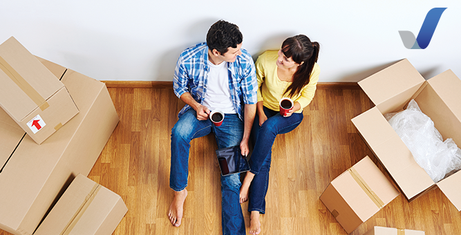 Couple unpacking their possessions in their new house