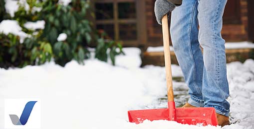 Shoveling snow in front of business for winter